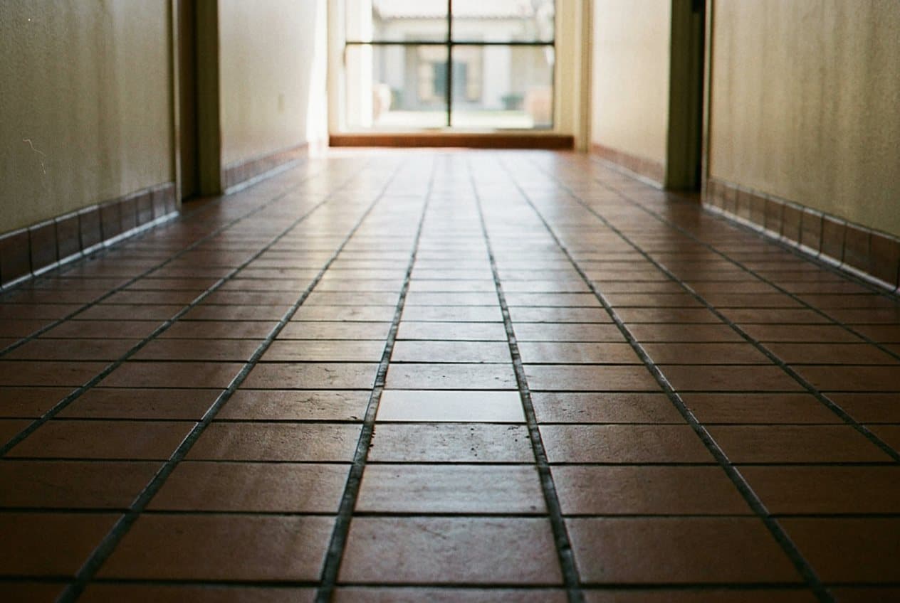 Seamlessly patched terracotta tile in a hallway